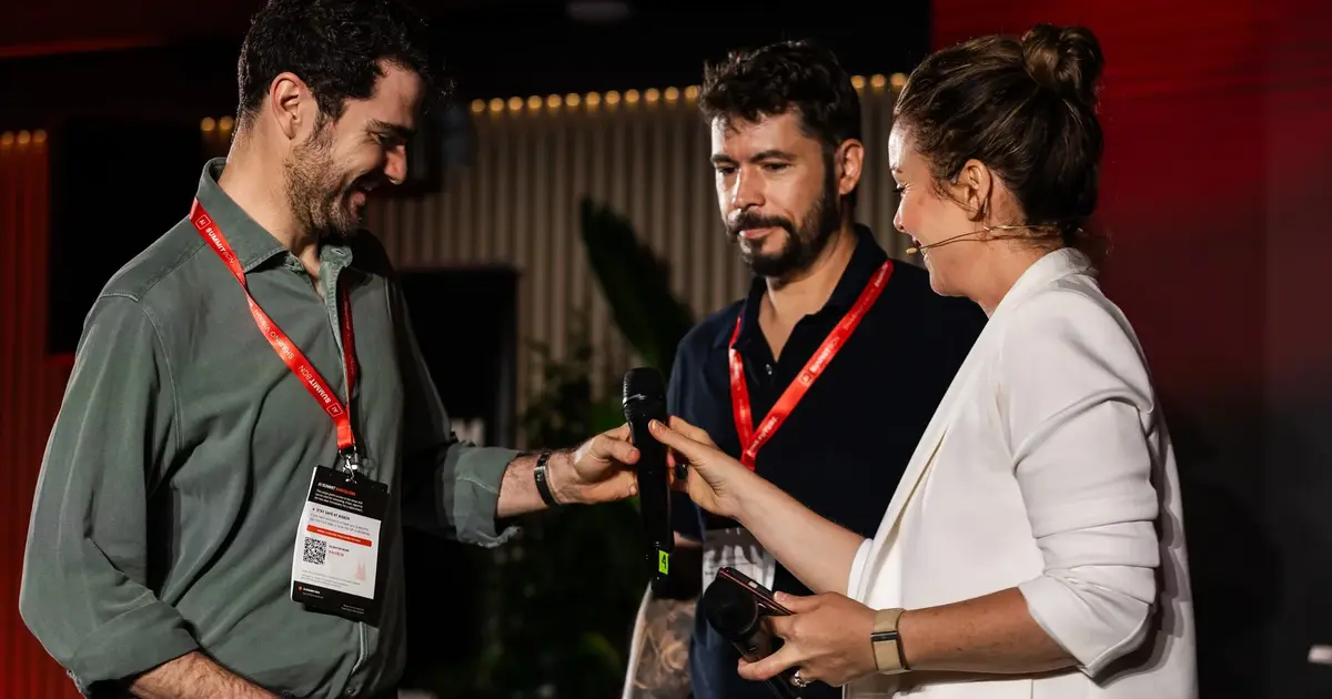 Three conference participants in conversation between sessions.