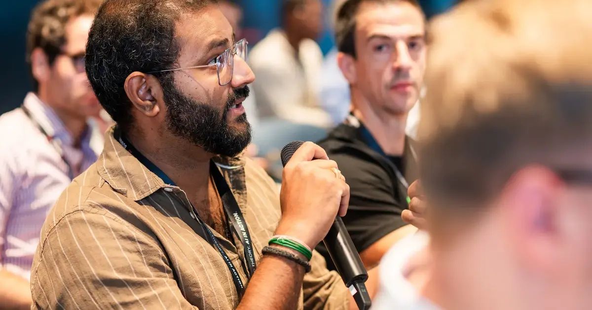 An attendee asking a question with a handheld microphone.
